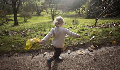 Girl running with autumnal leaf