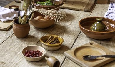 An array of ingredients in bowls set out on a wooden table